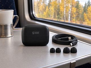 Закрытый чёрный кейс CGPods Эйр Про на столике в поезде, рядом кабель Type-C и запасные амбушюры